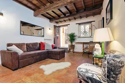a living room with a brown couch and chairs at San Callisto in Rome