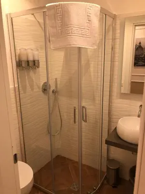 a shower in a bathroom with a toilet and a sink at Pantheon Luxury Suite in Rome