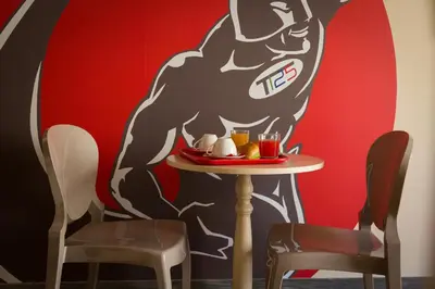 a table in front of a mural of a dog at Tritone 125 Suite in Rome