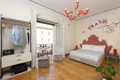 a bedroom with a bed and a sign on the wall at Tritone 125 Suite in Rome
