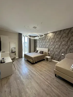 a large bedroom with a bed and a couch at TrevInn Suites in Rome