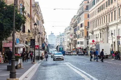 a city street with cars and people walking on the street at Lovely New Home, Via Nazionale in Rome