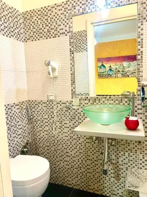 a bathroom with a sink and a toilet and a mirror at B&B A Home in Rome in Rome