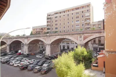 a large bridge with cars parked in a parking lot at San Peter Apartment - your home in the heart of Rome in Rome