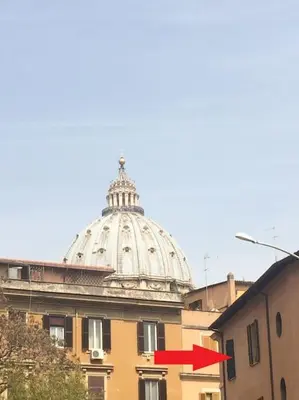 a building with a domed building with a red arrow at San Peter Apartment - your home in the heart of Rome in Rome