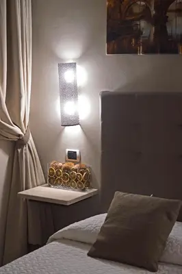 a bedroom with a bed and a lamp on a table at Domus Catone in Rome