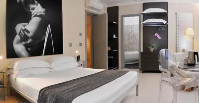 a bedroom with a large white bed and a bathroom at B&B Best Pantheon in Rome