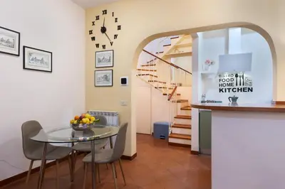 a dining room with a glass table and a staircase at Colosseum private terrace in Rome