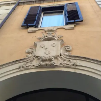 a building with a face over a doorway at Colosseum private terrace in Rome