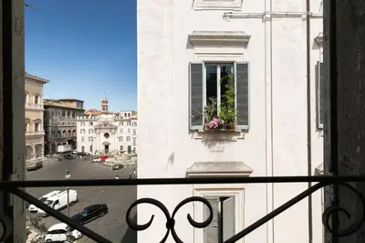 a view from a balcony of a building with a window at Farnese Charming Apartment in Rome
