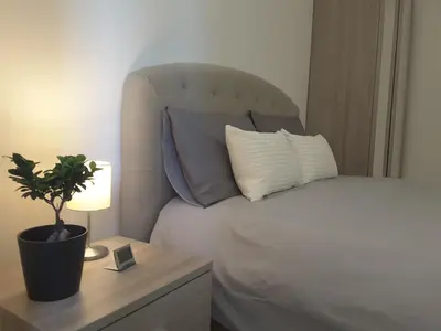 a bedroom with a bed and a table with a potted plant at Dino Apartment in Rome