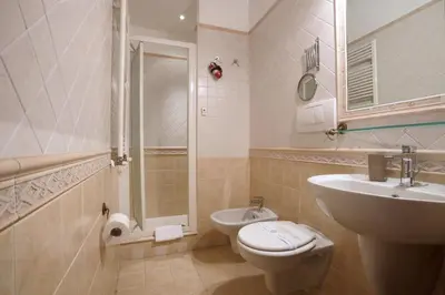 a bathroom with a sink and a toilet and a shower at Borgo Pio 91 in Rome