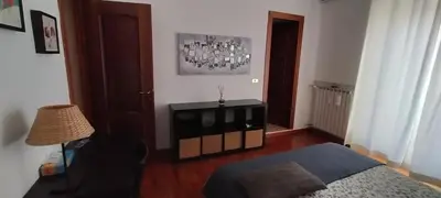 a bedroom with a bed and a lamp and a table at Pigneto Suite appartamento 50 m da metro C in Rome