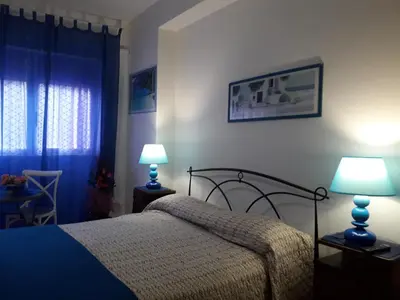 a bedroom with a bed and two lamps on tables at Apartament Silvy Trastevere in Rome
