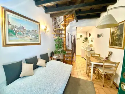 a living room with a bed and a dining room at Karma House Deluxe Navona in Rome