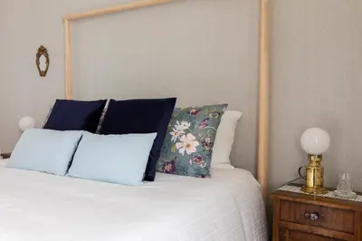 a bedroom with a bed with a wooden headboard and pillows at Casa Otto in Rome