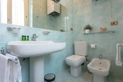 a bathroom with a white sink and a toilet at Vittoria Street Charming in Rome