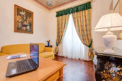 a laptop computer sitting on a table in a living room at Vittoria Street Charming in Rome