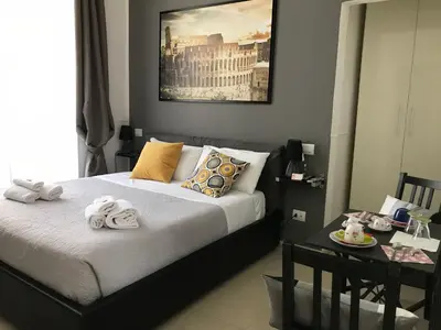 a bedroom with a bed and a table with towels on it at Vatican City Holidays Guesthouse in Rome