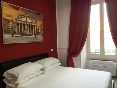 a bedroom with a bed and a painting on the wall at Vatican City Holidays Guesthouse in Rome