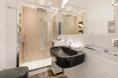 a bathroom with a black sink and a shower at Le Stanze Di Elle in Rome