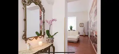 a living room with a mirror and a table at IN FRONT OF COLISEUM 2 in Rome