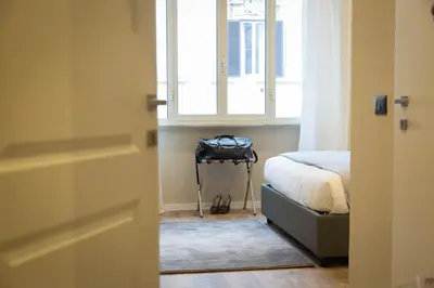 a bedroom with a bed and a window at 126 Gracchi Suites in Rome