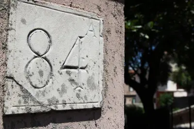 a stone sign on a wall with a number on it at Vaticano84 in Rome