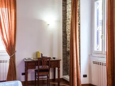 a desk and chair in a room with a window at Apartment Domus Fori by Interhome in Rome
