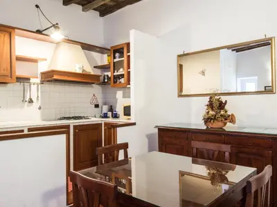 a kitchen with a table and a mirror at Apartment Domus Fori by Interhome in Rome