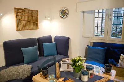 a living room with blue couches and a table at Private Modern Studio Paolina City Center in Rome