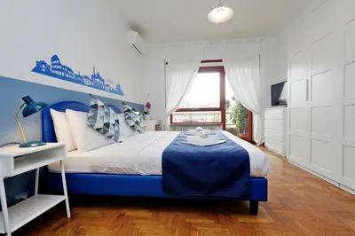 a blue and white bedroom with a bed and a window at YCH-TRASTEVERE cozy flat for 8 people in Rome