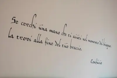 a handwritten text on a white wall with writing at Vatican Meadows in Rome