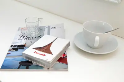 a book and a cup of coffee on a table at Piazza del Popolo Apartment in Rome