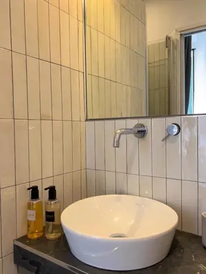 a white sink in a bathroom with a mirror at Royal Suite du Vatican in Rome