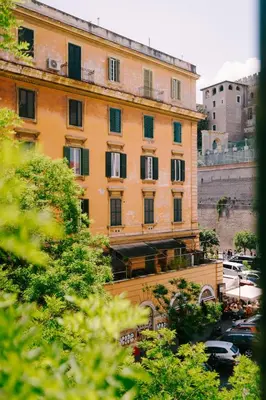 a large orange building with windows in a city at Royal Suite du Vatican in Rome