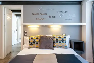 a bedroom with a bed with a sign above it at Modern Loft Walk to St Peter IREX Apartment in Rome