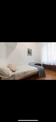 a bed in a white room with a window at IN FRONT OF COLISEUM 3 in Rome