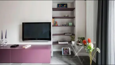 a living room with a tv and a purple cabinet at Moma Roma in Rome