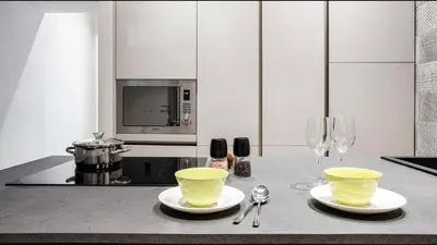 a kitchen with two yellow bowls and glasses on a counter at Moma Roma in Rome