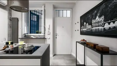 a kitchen with a large painting on the wall at Moma Roma in Rome