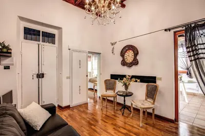 a living room with a couch and a table and chairs at Colosseo Miracle Suite in Rome