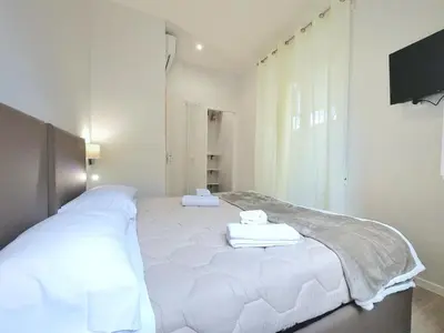 a white bed with towels on it in a room at Vatican Luxury Corner in Rome