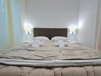 a large bed with two pillows in a bedroom at Vatican Luxury Corner in Rome