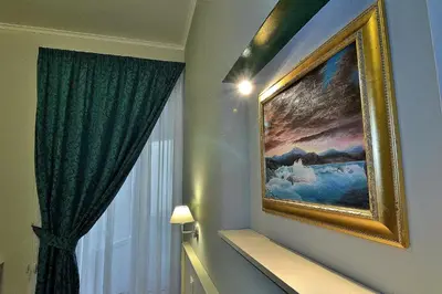 a painting hanging on a wall next to a window at Ottaviano Guest House in Rome