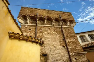 a tall brick building with a clock tower at Guesthouse MySuiteTower Pantheon in Rome