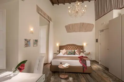 a bedroom with a bed and a chandelier at Guesthouse MySuiteTower Pantheon in Rome
