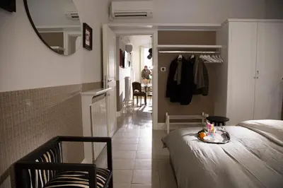 a bedroom with a bed and a mirror and a hallway at Vatican Jewel Apartment in Rome