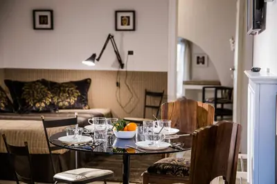 a table with glasses on it in a living room at Vatican Jewel Apartment in Rome