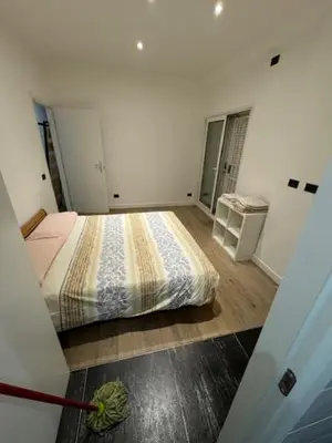 a bedroom with a bed and a table in it at Alloggio Roma Appia in Rome